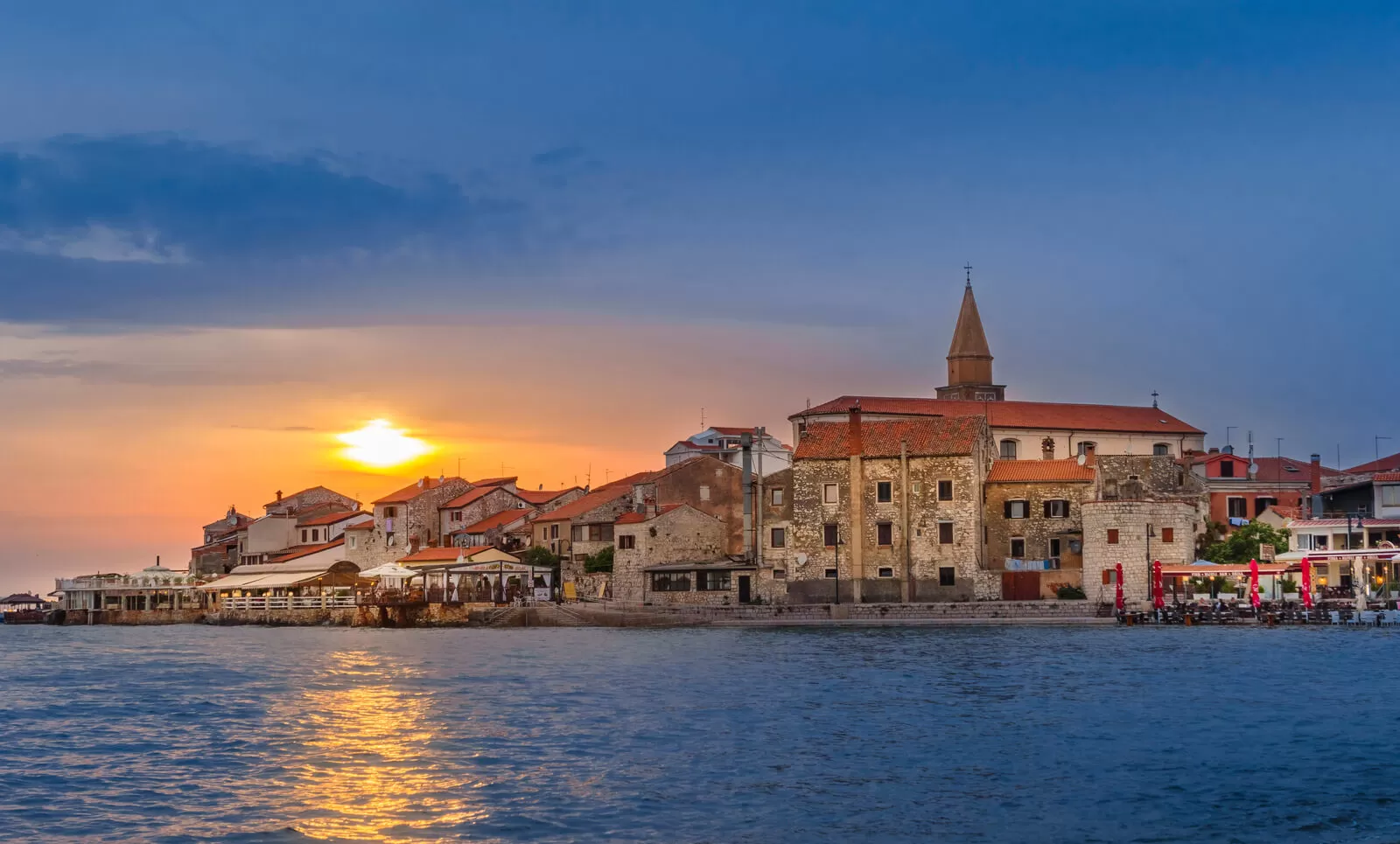 Enjoy the promenade with a view of the sunset and charming Umag
